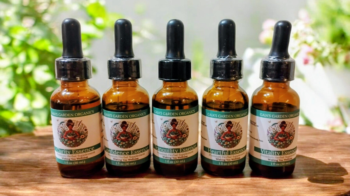 Organic flower essences in garden setting with fresh lavender and rose flowers